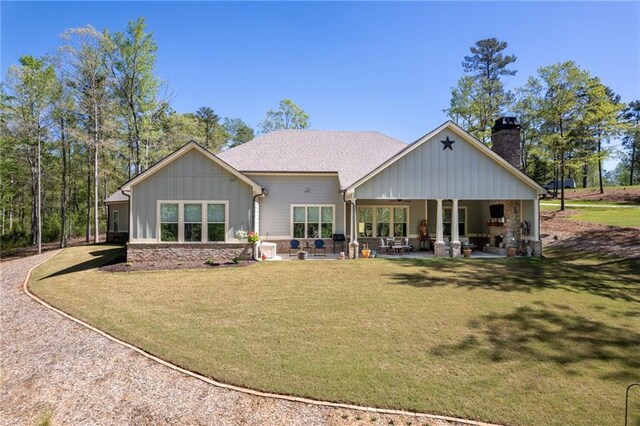 back of property with a patio area and a lawn