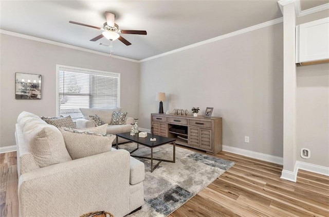 living room featuring wood-type flooring, ornamental molding, and ceiling fan