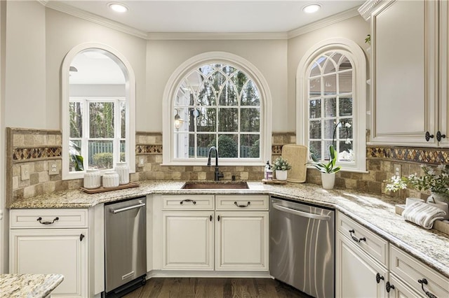 interior space featuring ornamental molding, stainless steel dishwasher, a sink, and dark wood finished floors