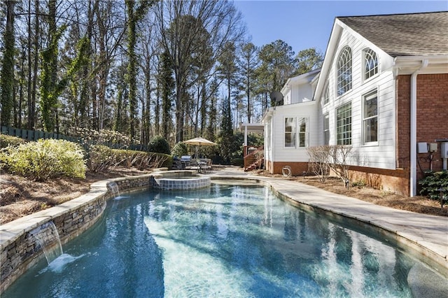 view of swimming pool featuring a patio and a pool with connected hot tub