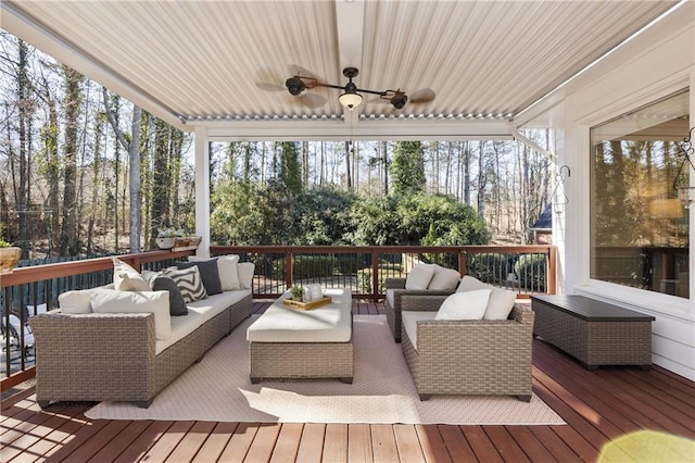 sunroom / solarium featuring ceiling fan