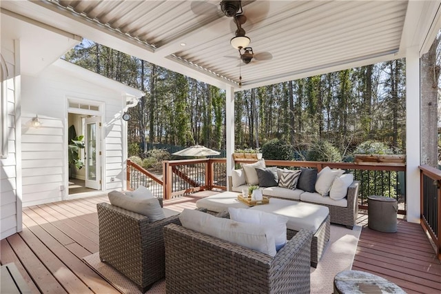 wooden deck with ceiling fan and an outdoor hangout area