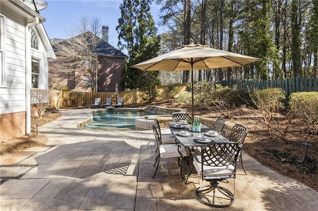 view of patio / terrace with outdoor dining area, a fenced backyard, and a fenced in pool