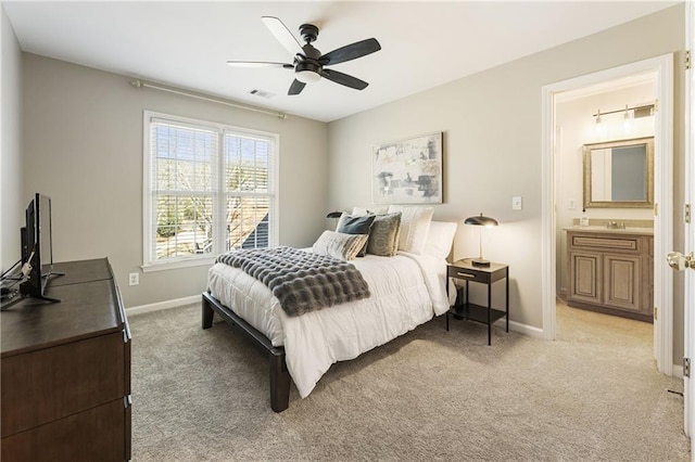 bedroom with baseboards, a sink, visible vents, and light colored carpet