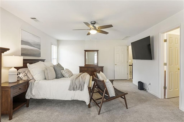 bedroom with ceiling fan, visible vents, and light colored carpet