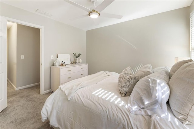 bedroom with light carpet, visible vents, a ceiling fan, and baseboards