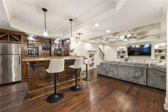 bar featuring dark wood-style floors, a raised ceiling, freestanding refrigerator, and crown molding