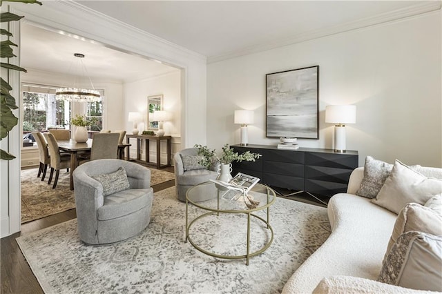 living room featuring a chandelier, wood finished floors, and crown molding