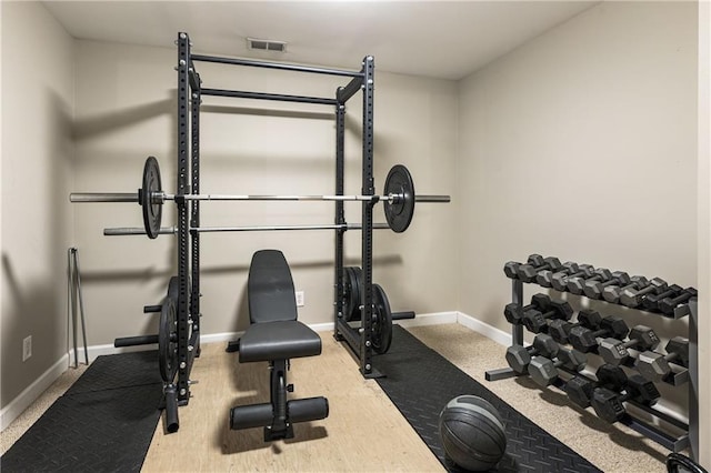 exercise room featuring carpet, baseboards, and visible vents