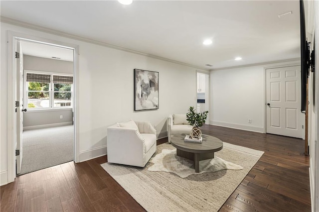 living area featuring baseboards, dark wood-style flooring, and crown molding