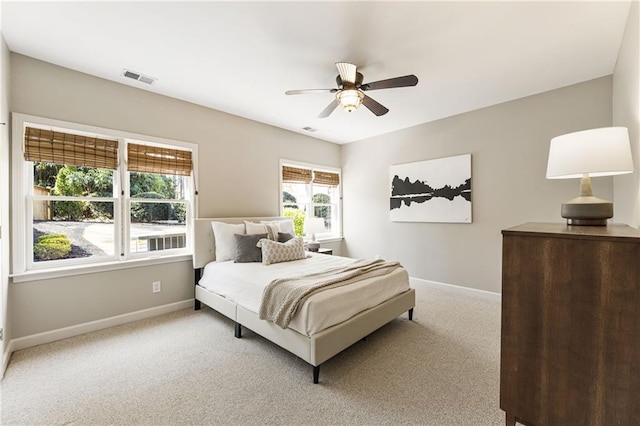 bedroom with ceiling fan, carpet floors, visible vents, and baseboards