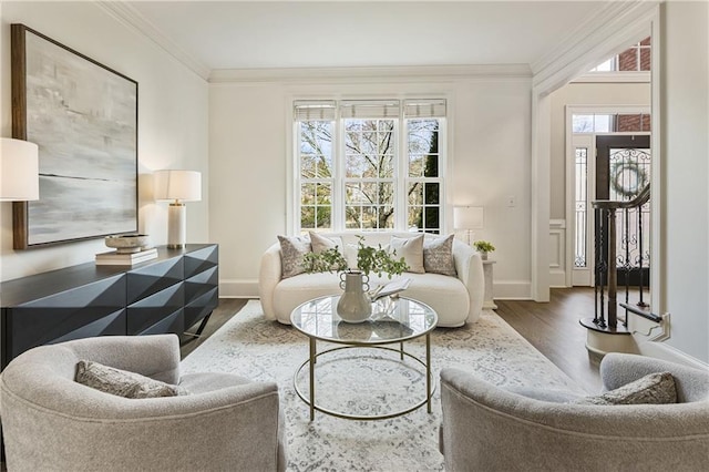 living room with baseboards, wood finished floors, and crown molding