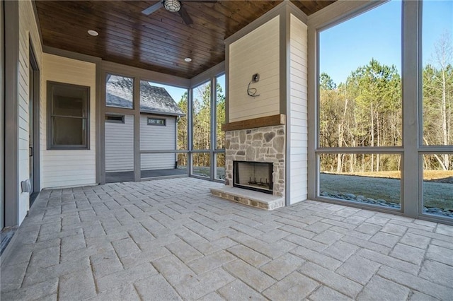 526 Spring Place Rd NE, White, GA 30184 - unfurnished sunroom featuring an outdoor stone fireplace and ceiling fan