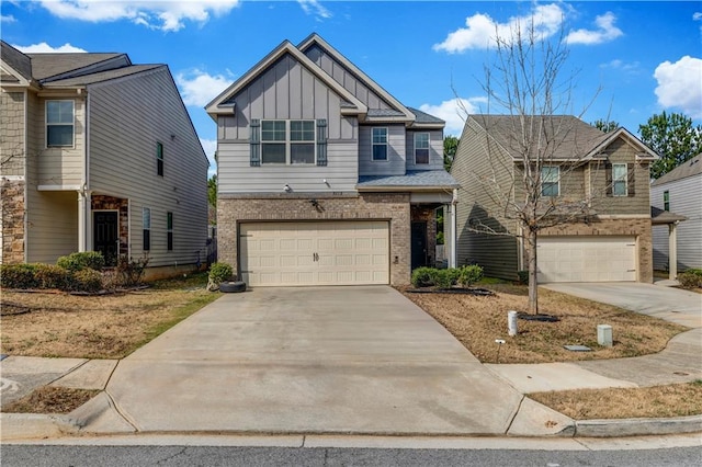 craftsman house with a garage, concrete driveway, brick siding, and board and batten siding