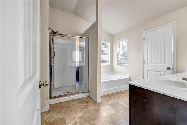 bathroom featuring vaulted ceiling, vanity, a shower stall, and a bath