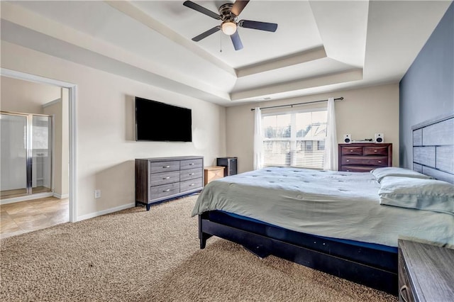 bedroom featuring ceiling fan, carpet floors, a raised ceiling, and baseboards