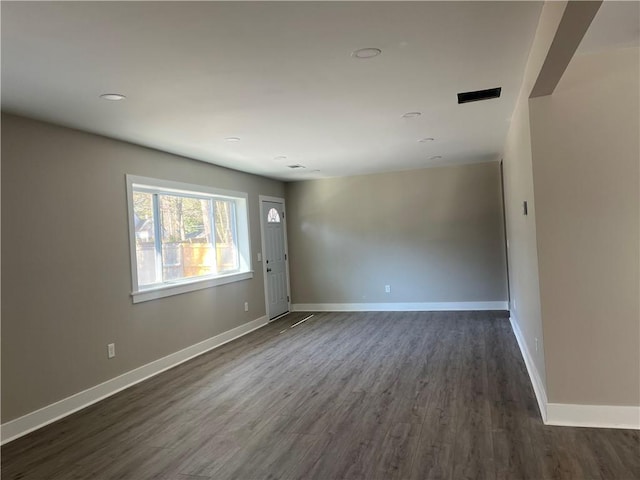 unfurnished room featuring dark hardwood / wood-style flooring