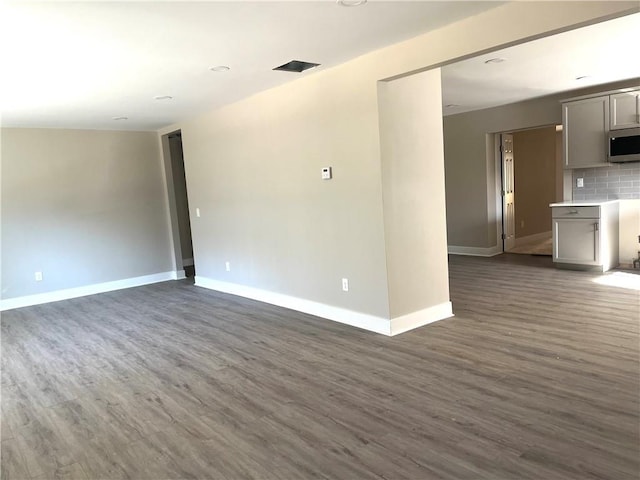 spare room featuring dark hardwood / wood-style flooring