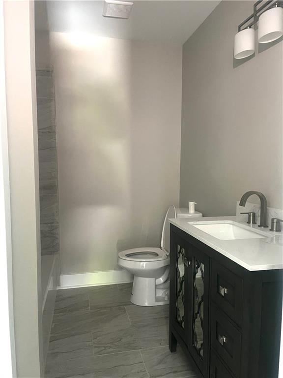 bathroom featuring vanity and toilet