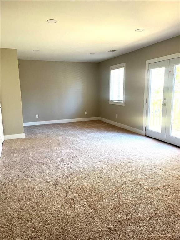 spare room featuring french doors and carpet floors