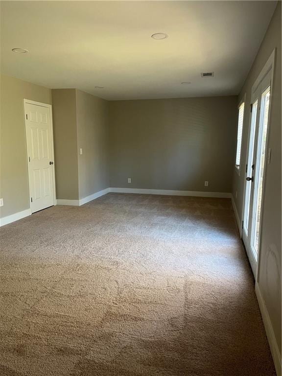 unfurnished room featuring carpet