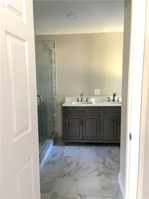 bathroom featuring vanity and an enclosed shower