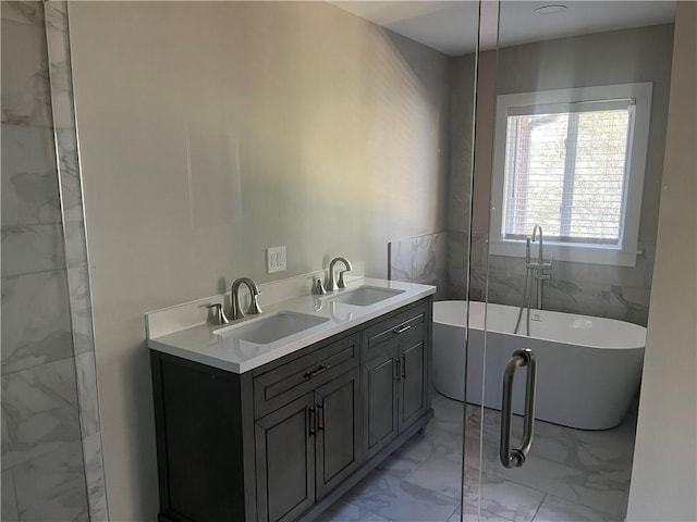 bathroom with a tub to relax in, vanity, and tile walls