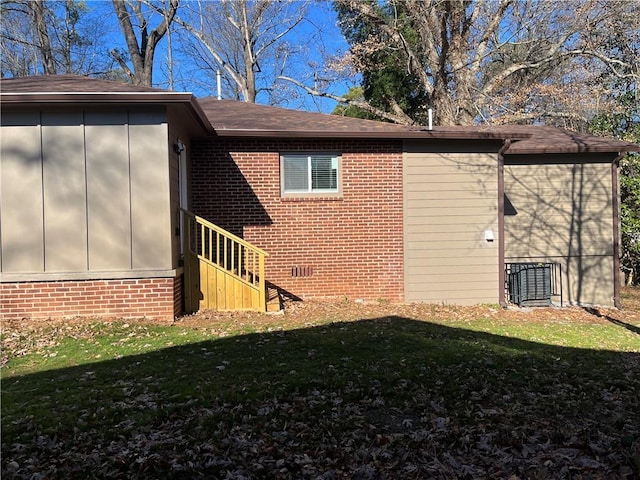 rear view of property featuring a lawn