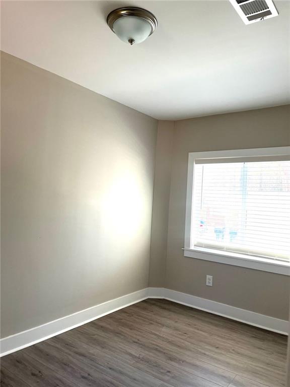 spare room with dark wood-type flooring