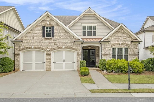 11375 Crestview Ter, Johns Creek, GA 30024 - view of front of property featuring brick siding, concrete driveway, french doors, a standing seam roof, and a garage