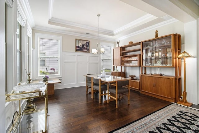11375 Crestview Ter, Johns Creek, GA 30024 - dining space featuring dark wood-type flooring, a chandelier, a decorative wall, ornamental molding, and a raised ceiling