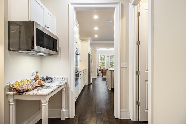 11375 Crestview Ter, Johns Creek, GA 30024 - kitchen featuring appliances with stainless steel finishes, ornamental molding, white cabinetry, dark wood-type flooring, and baseboards