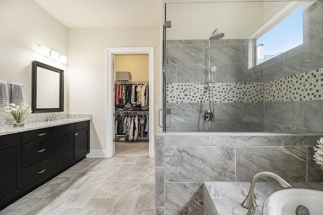 11375 Crestview Ter, Johns Creek, GA 30024 - full bath with a stall shower, vanity, a bath, a walk in closet, and baseboards