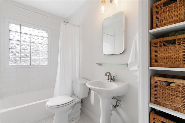 bathroom featuring shower / tub combo with curtain, tile patterned floors, and toilet