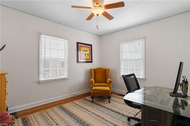 office space featuring hardwood / wood-style flooring, a healthy amount of sunlight, and ceiling fan