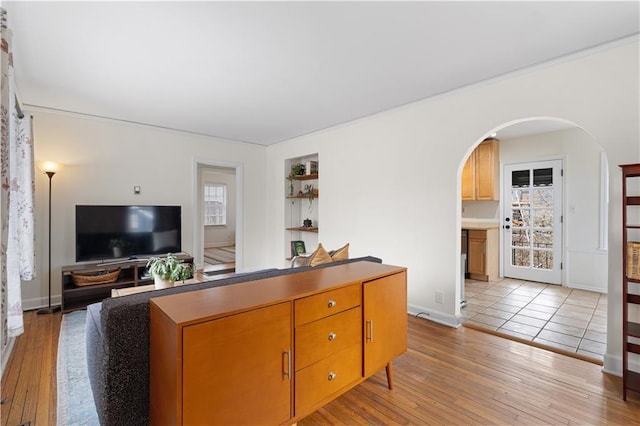 living room with light hardwood / wood-style floors and built in shelves