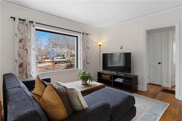 living room featuring hardwood / wood-style floors and ornamental molding