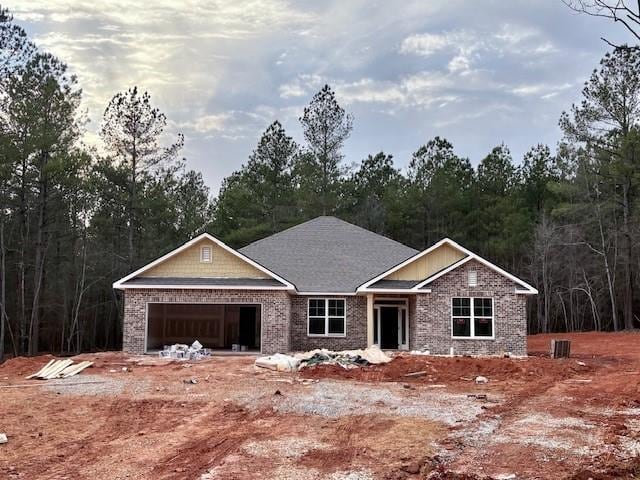 view of front of property with a garage, cooling unit, and brick siding