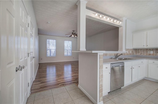 kitchen with ceiling fan, dishwasher, light tile patterned floors, ornate columns, and a sink