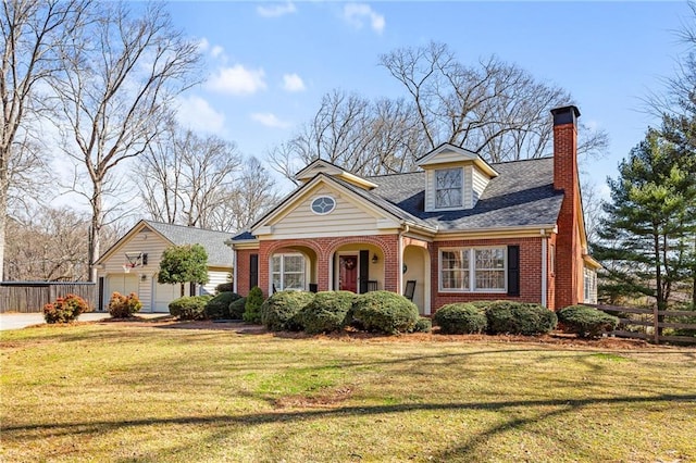 view of front of home featuring brick siding, a chimney, roof with shingles, fence, and a front yard