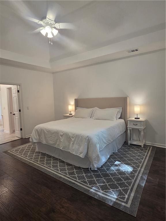 1045 River Pt, Suwanee, GA 30024 - bedroom with wood finished floors, a ceiling fan, and a raised ceiling