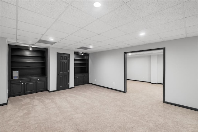 1045 River Pt, Suwanee, GA 30024 - finished below grade area with light carpet, built in features, a paneled ceiling, and recessed lighting
