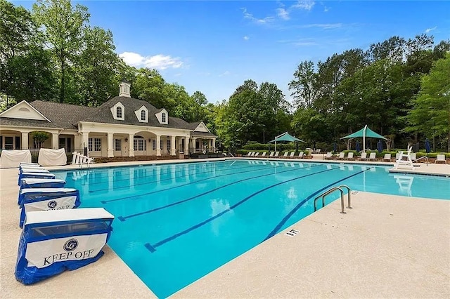 1045 River Pt, Suwanee, GA 30024 - community pool with view of scattered trees and a patio