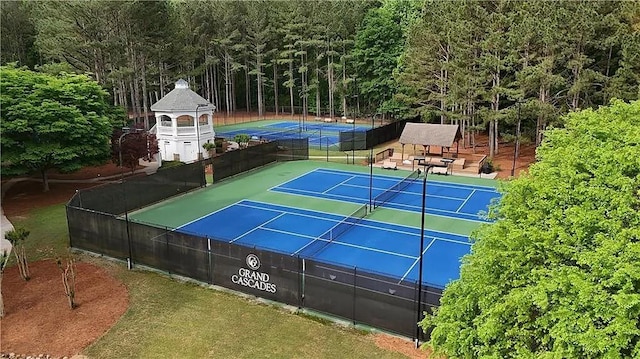 1045 River Pt, Suwanee, GA 30024 - view of tennis court with a wooded view