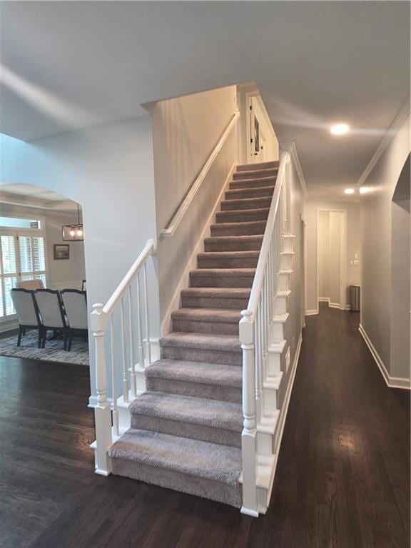 1045 River Pt, Suwanee, GA 30024 - stairs featuring wood finished floors, arched walkways, and crown molding