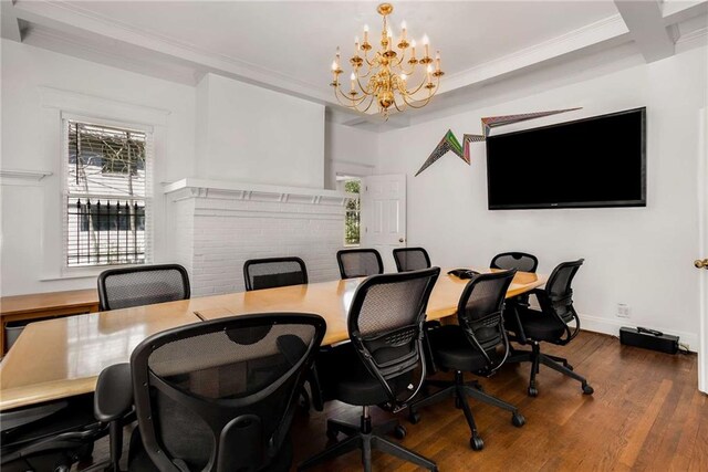 interior space with a notable chandelier, ornamental molding, and hardwood / wood-style floors