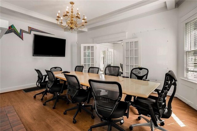 home office with an inviting chandelier, light wood-type flooring, french doors, and crown molding