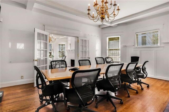 dining area with ornamental molding, hardwood / wood-style floors, and a chandelier