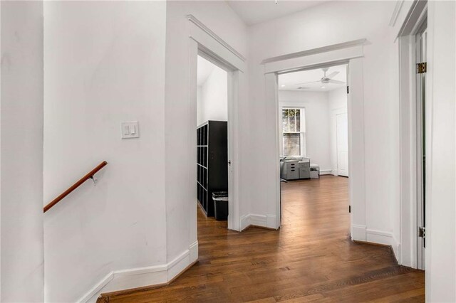 hallway with dark hardwood / wood-style flooring