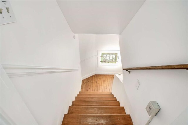 stairs featuring wood-type flooring